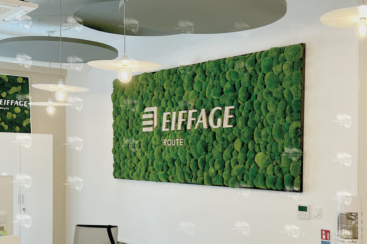 Cadre Vegetal avec une enseigne en bois, massif Mur végétal décoratif avec le logo d'EIFFAGE en relief. Éclairage moderne.